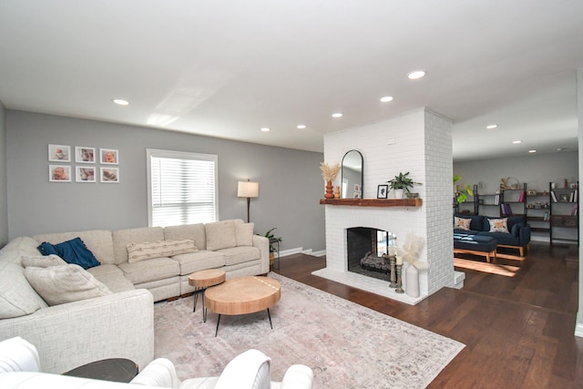 living room with a fireplace and dark hardwood / wood-style floors