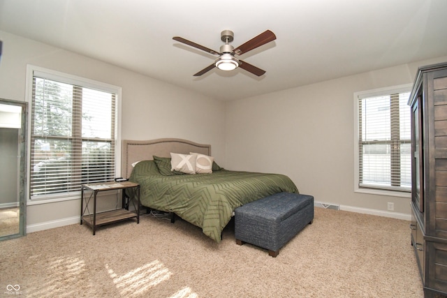 bedroom featuring light carpet and ceiling fan