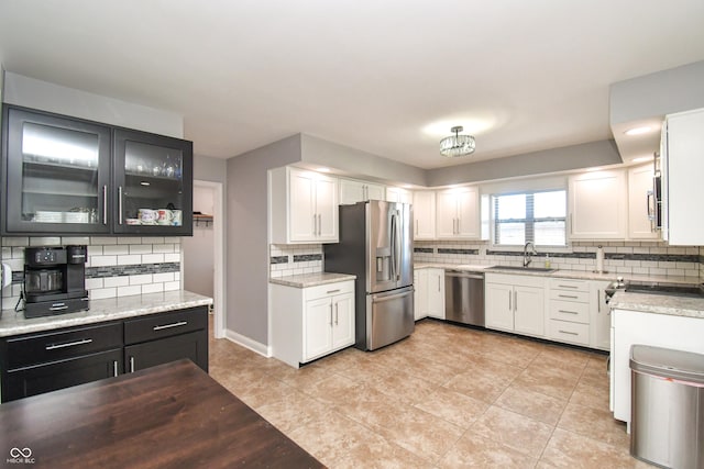 kitchen with white cabinetry, stainless steel appliances, and sink