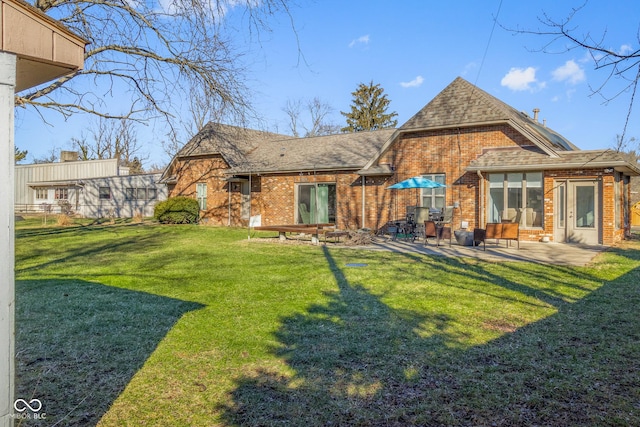 back of property with a patio and a lawn