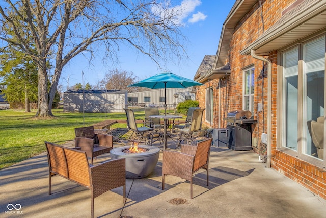 view of patio / terrace featuring an outdoor fire pit and a grill