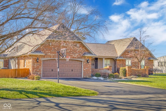 view of front of house with a garage and a front yard