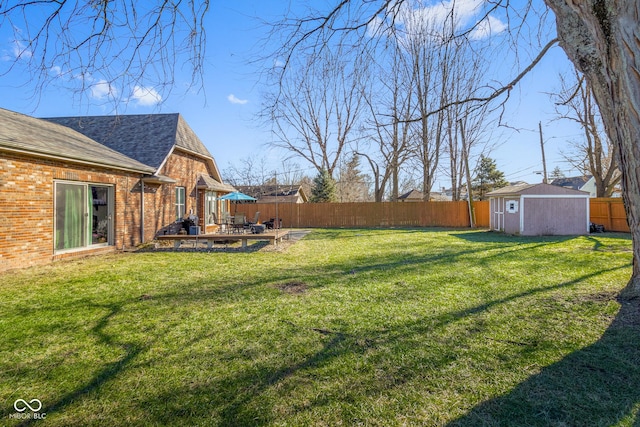 view of yard featuring a storage shed and a patio