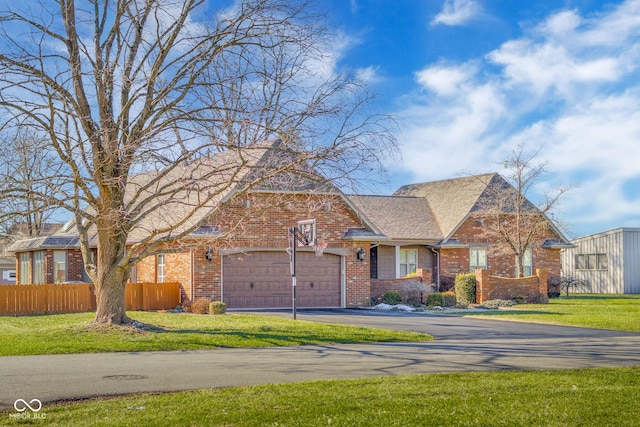 view of front facade with a garage and a front yard