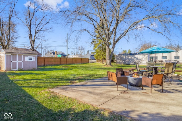 view of patio featuring a storage unit and an outdoor fire pit