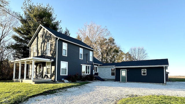 view of front of home featuring a porch and a front lawn