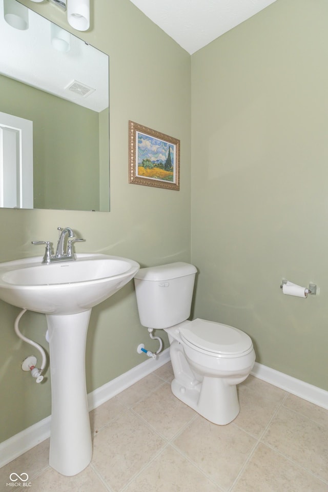 bathroom featuring toilet and tile patterned flooring