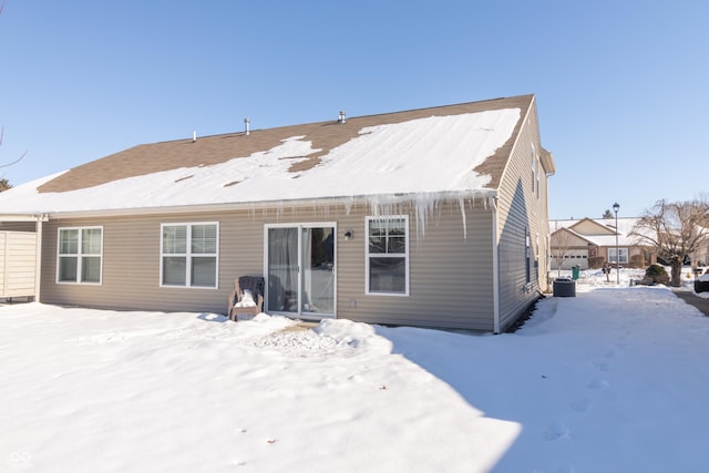 view of snow covered rear of property