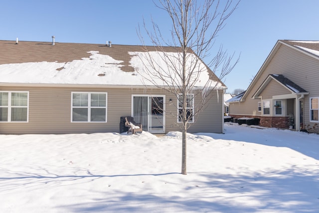 view of snow covered back of property