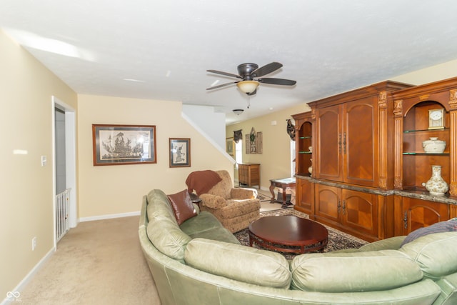 living room with ceiling fan and light colored carpet