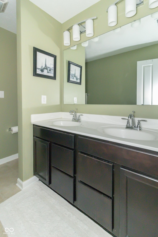 bathroom featuring tile patterned flooring and vanity