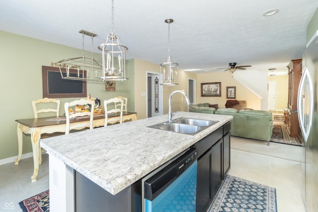 kitchen featuring hanging light fixtures, stainless steel appliances, a center island with sink, ceiling fan, and sink