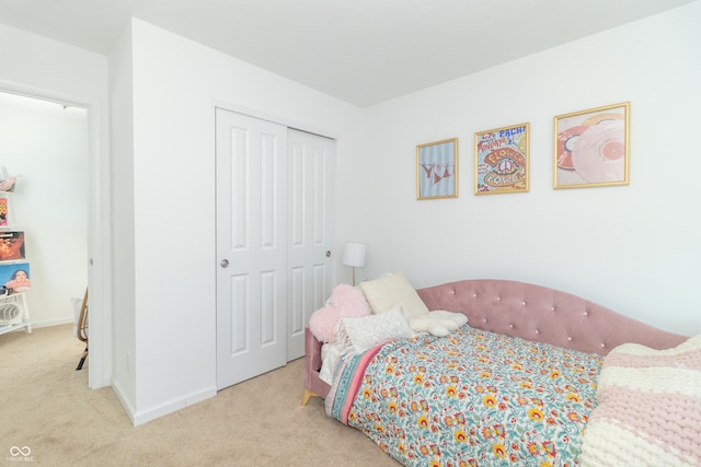 bedroom featuring a closet and light colored carpet