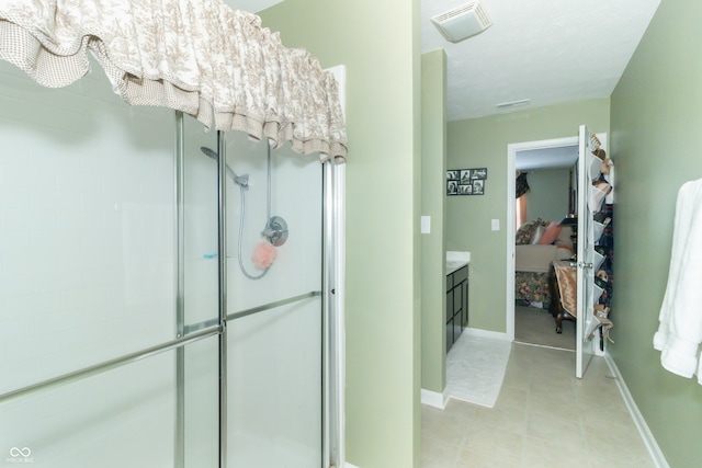 bathroom featuring an enclosed shower and vanity