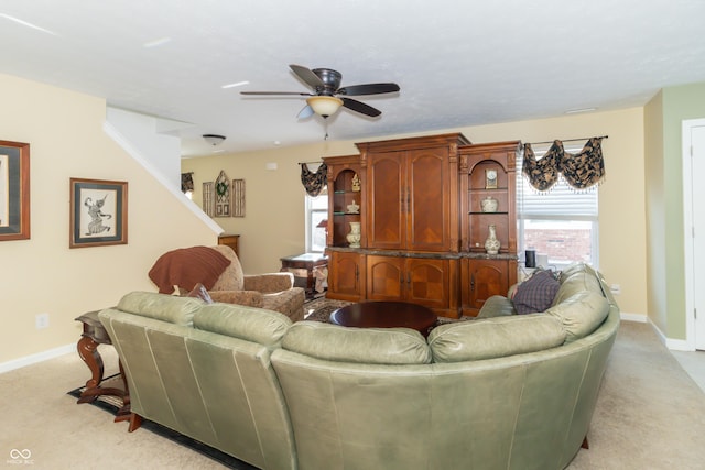 living room with ceiling fan and light colored carpet