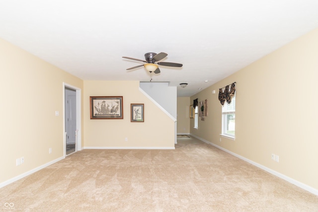 1226 Arlington Dr, Greenfield, IN 46140 - empty room with a ceiling fan, light colored carpet, and stairway