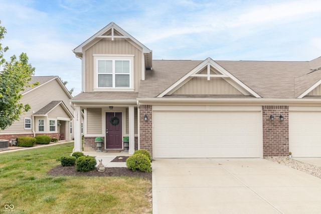 1226 Arlington Dr, Greenfield, IN 46140 - view of front facade with brick siding, board and batten siding, a front yard, and driveway