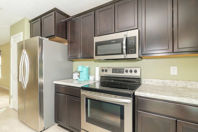 1226 Arlington Dr, Greenfield, IN 46140 - kitchen with appliances with stainless steel finishes, dark brown cabinets, and light countertops