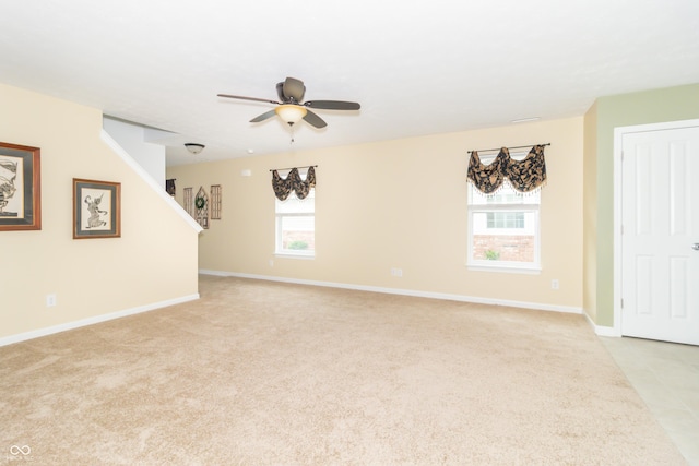 1226 Arlington Dr, Greenfield, IN 46140 - unfurnished living room featuring light colored carpet, a ceiling fan, and stairway