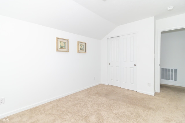 1226 Arlington Dr, Greenfield, IN 46140 - unfurnished bedroom with vaulted ceiling, light colored carpet, and a closet