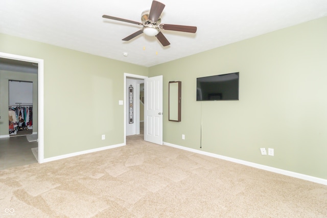 1226 Arlington Dr, Greenfield, IN 46140 - unfurnished bedroom with carpet floors, a walk in closet, and a ceiling fan