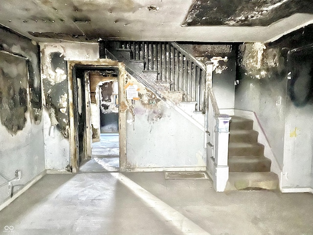 stairs featuring concrete flooring