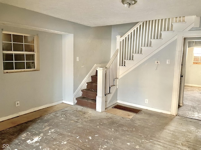 stairway with a textured ceiling