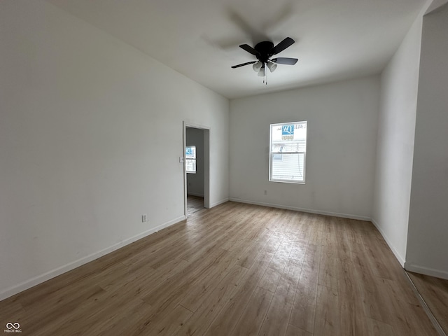 empty room with ceiling fan and light wood-type flooring