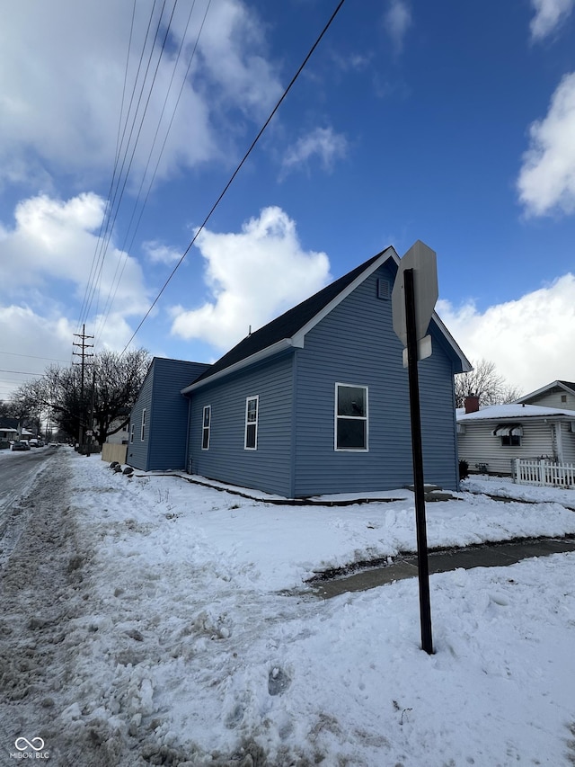 view of snow covered rear of property