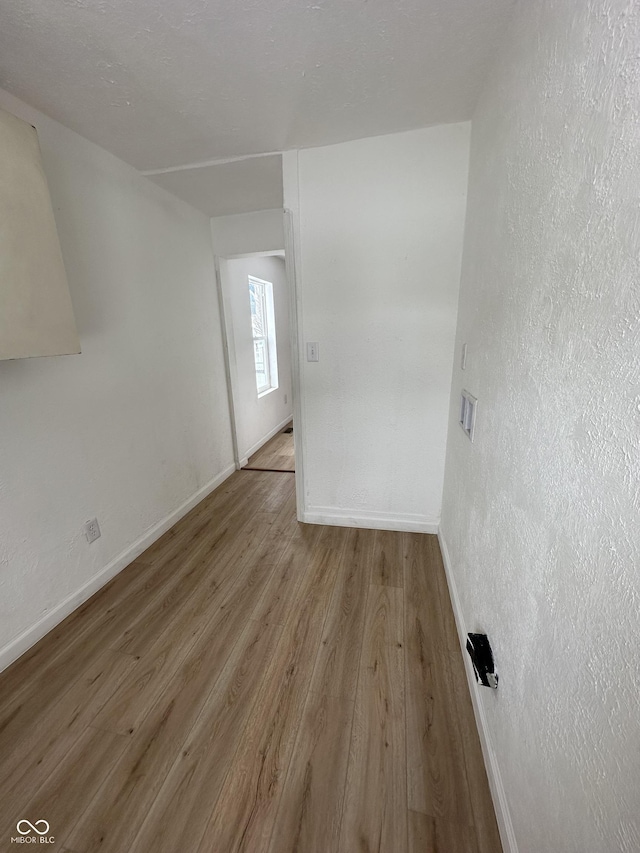 unfurnished room with light wood-type flooring