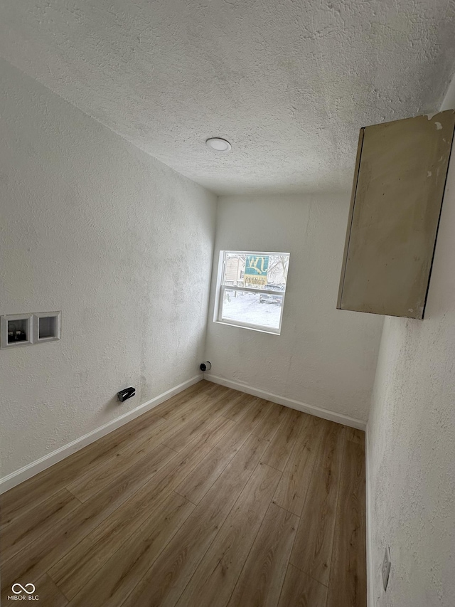 washroom with light hardwood / wood-style flooring and washer hookup