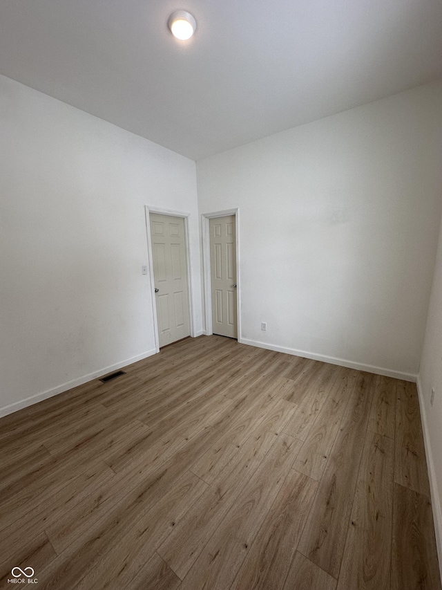 spare room featuring light hardwood / wood-style floors