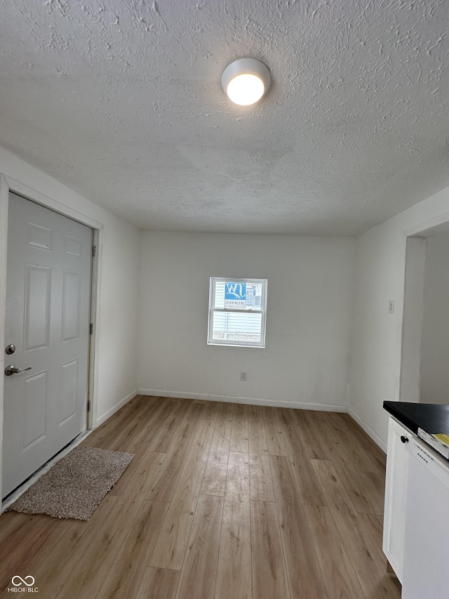 foyer featuring a textured ceiling and light hardwood / wood-style flooring