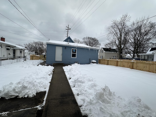 view of snow covered rear of property