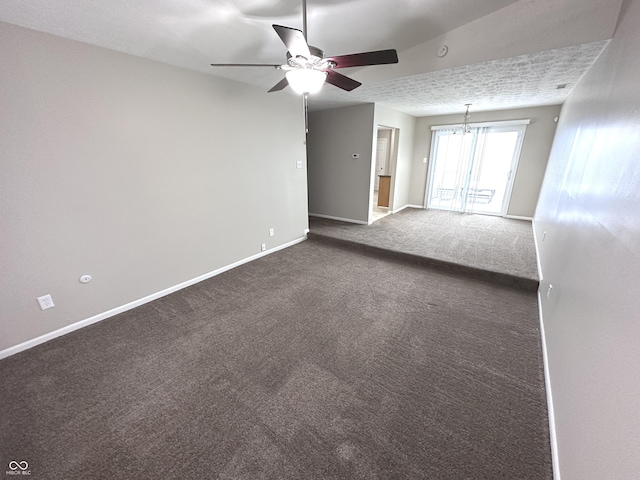 spare room with a textured ceiling, lofted ceiling, carpet, and ceiling fan with notable chandelier