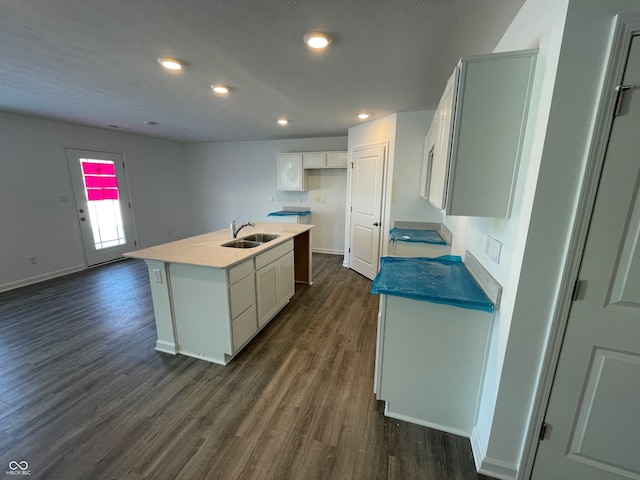 kitchen featuring white cabinetry, sink, an island with sink, and dark hardwood / wood-style floors