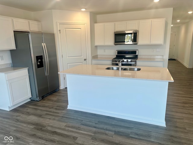 kitchen featuring stainless steel appliances, white cabinets, and dark wood-type flooring