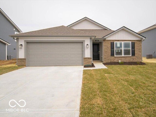 6618 Sulgrove Pl, Indianapolis, IN 46221 - ranch-style home featuring roof with shingles, driveway, an attached garage, and a front lawn