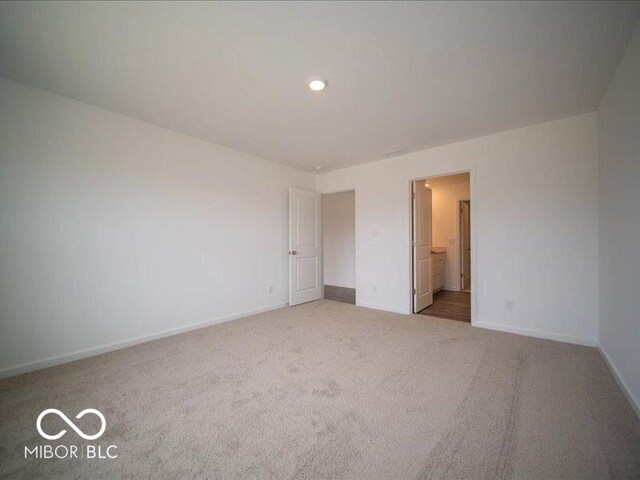 6618 Sulgrove Pl, Indianapolis, IN 46221 - unfurnished bedroom with baseboards, connected bathroom, recessed lighting, and carpet