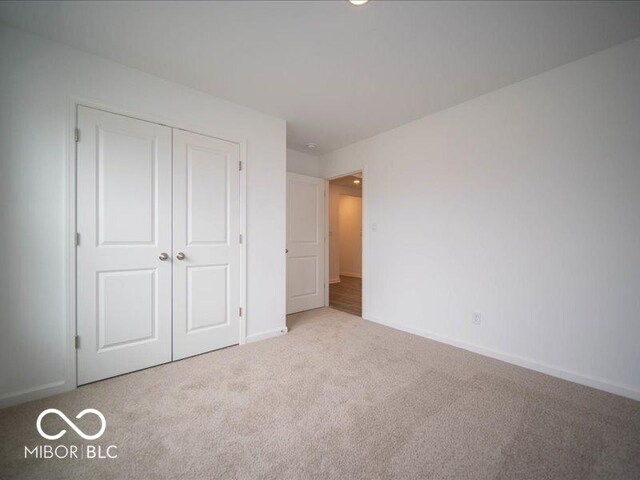 6618 Sulgrove Pl, Indianapolis, IN 46221 - unfurnished bedroom with a closet, baseboards, and carpet