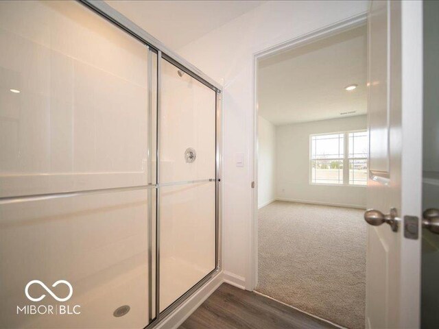 6618 Sulgrove Pl, Indianapolis, IN 46221 - bathroom featuring a stall shower, baseboards, and wood finished floors