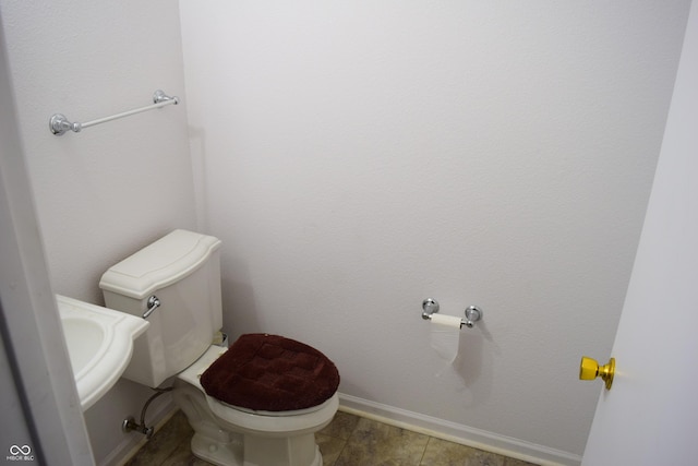 bathroom with tile patterned flooring and toilet