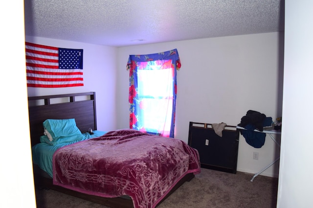 carpeted bedroom featuring a textured ceiling