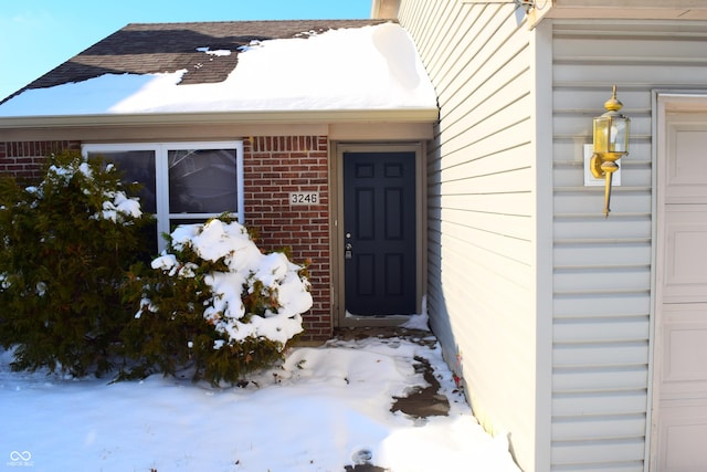 view of snow covered property entrance