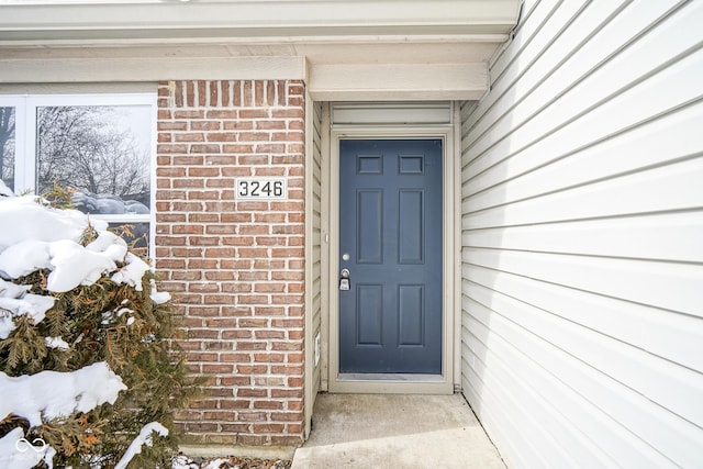 view of snow covered property entrance