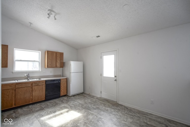 kitchen featuring lofted ceiling, white refrigerator, sink, a healthy amount of sunlight, and dishwasher