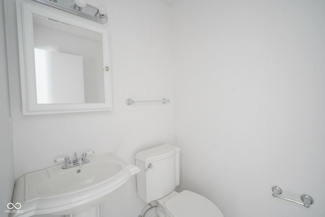 bathroom featuring sink and toilet