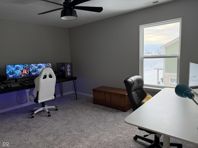 carpeted office space with ceiling fan