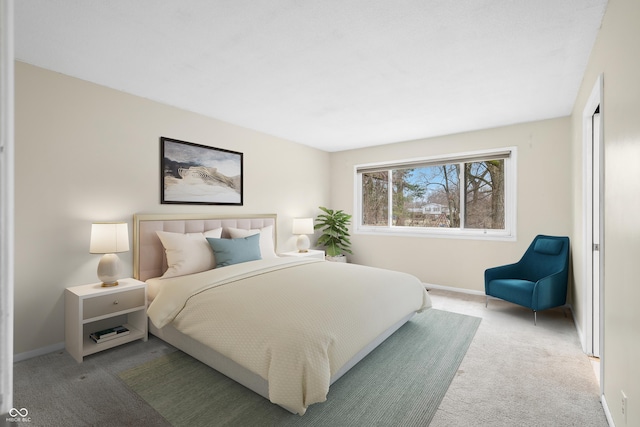 carpeted bedroom featuring baseboards