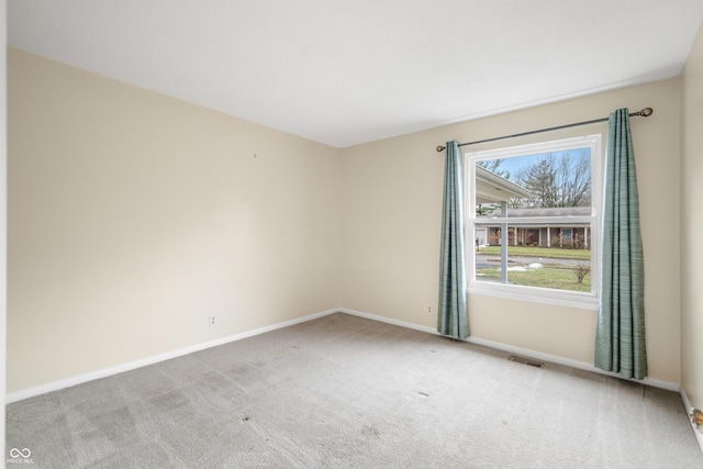 carpeted empty room with baseboards and visible vents